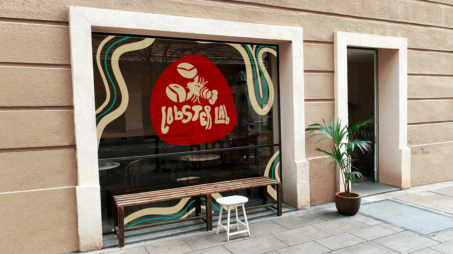 Lobster Lab storefront window signage — flowing wave patterns and logo on glass | Environmental design by Black Rabbit Creative