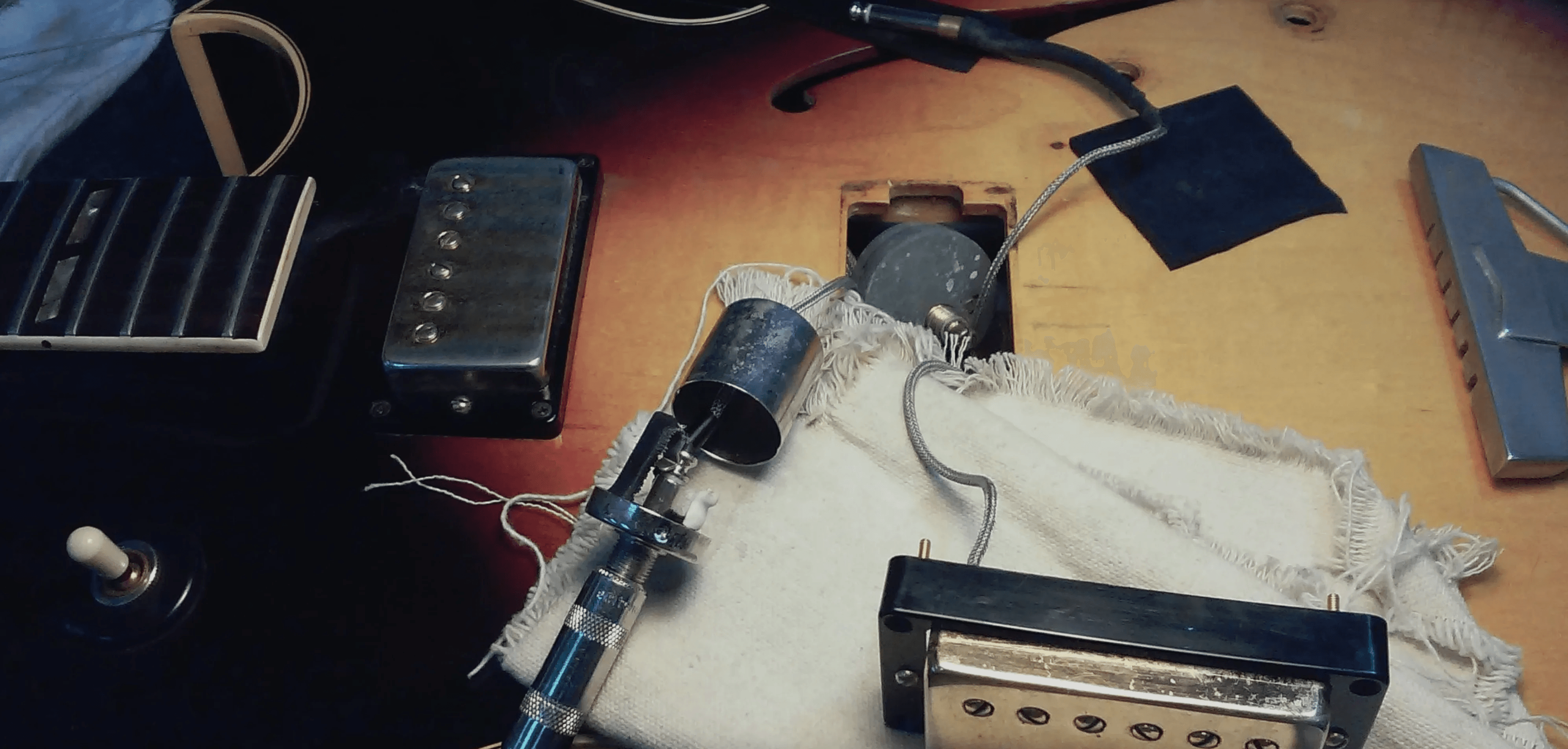 Authentic lutherie workspace showing guitar parts, wooden surfaces, tools, and materials that inspired the warm brand color palette | Black Rabbit Creative