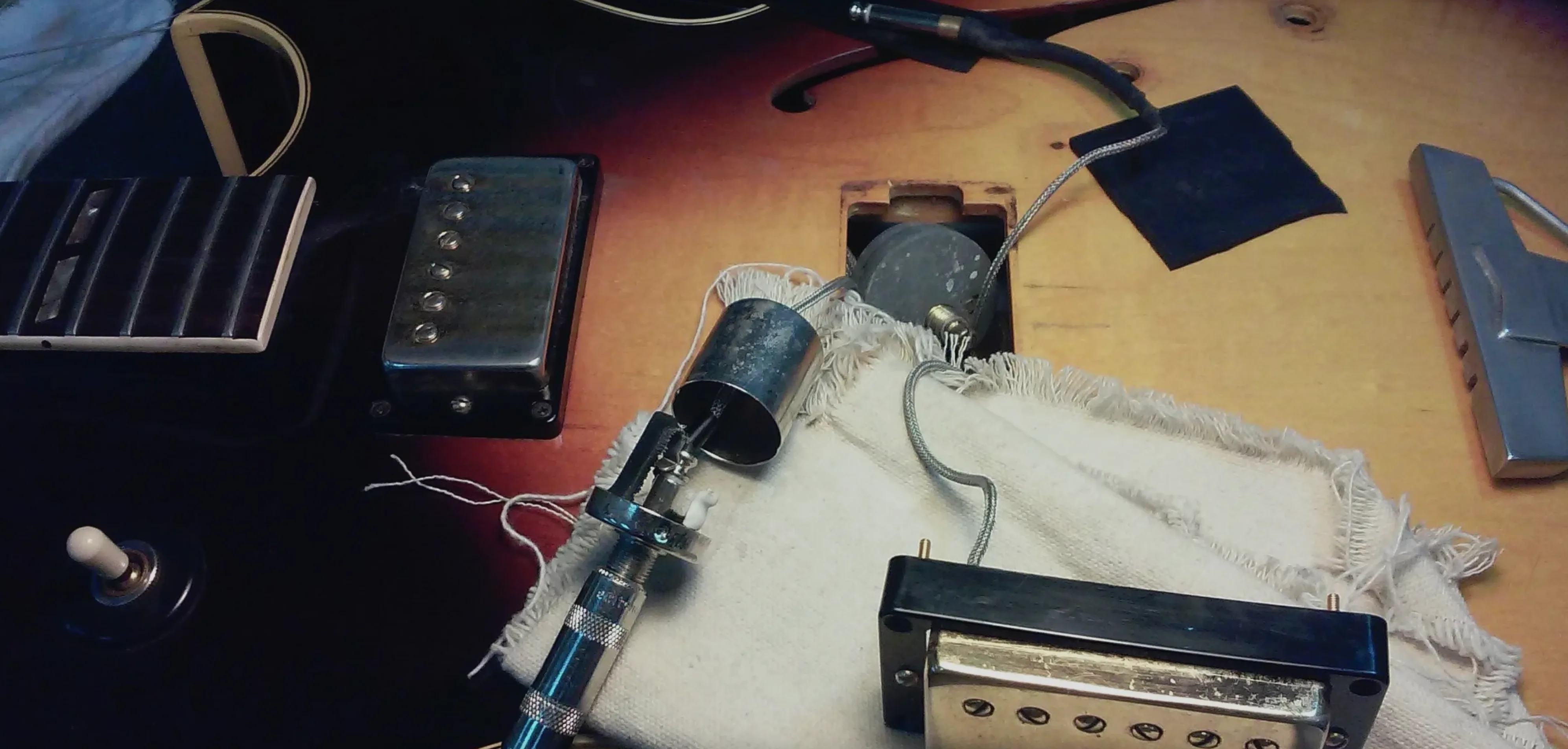 Authentic lutherie workspace showing guitar parts, wooden surfaces, tools, and materials that inspired the warm brand color palette | Black Rabbit Creative, Portsmouth NH, New Hampshire, New England